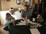 Dad showing Austin how to color.